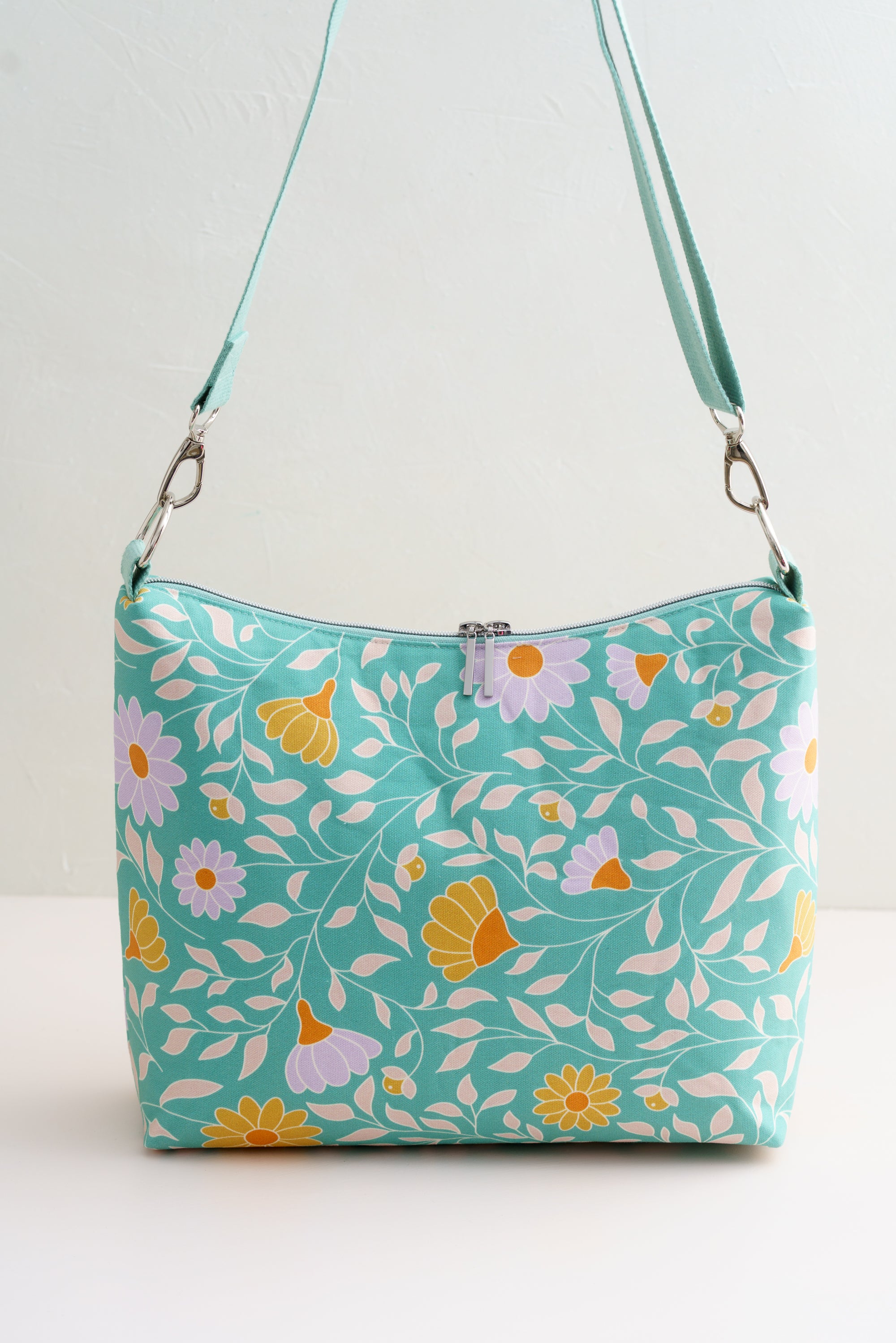 Crossbody Bag türkis mit floralem Grafikmuster