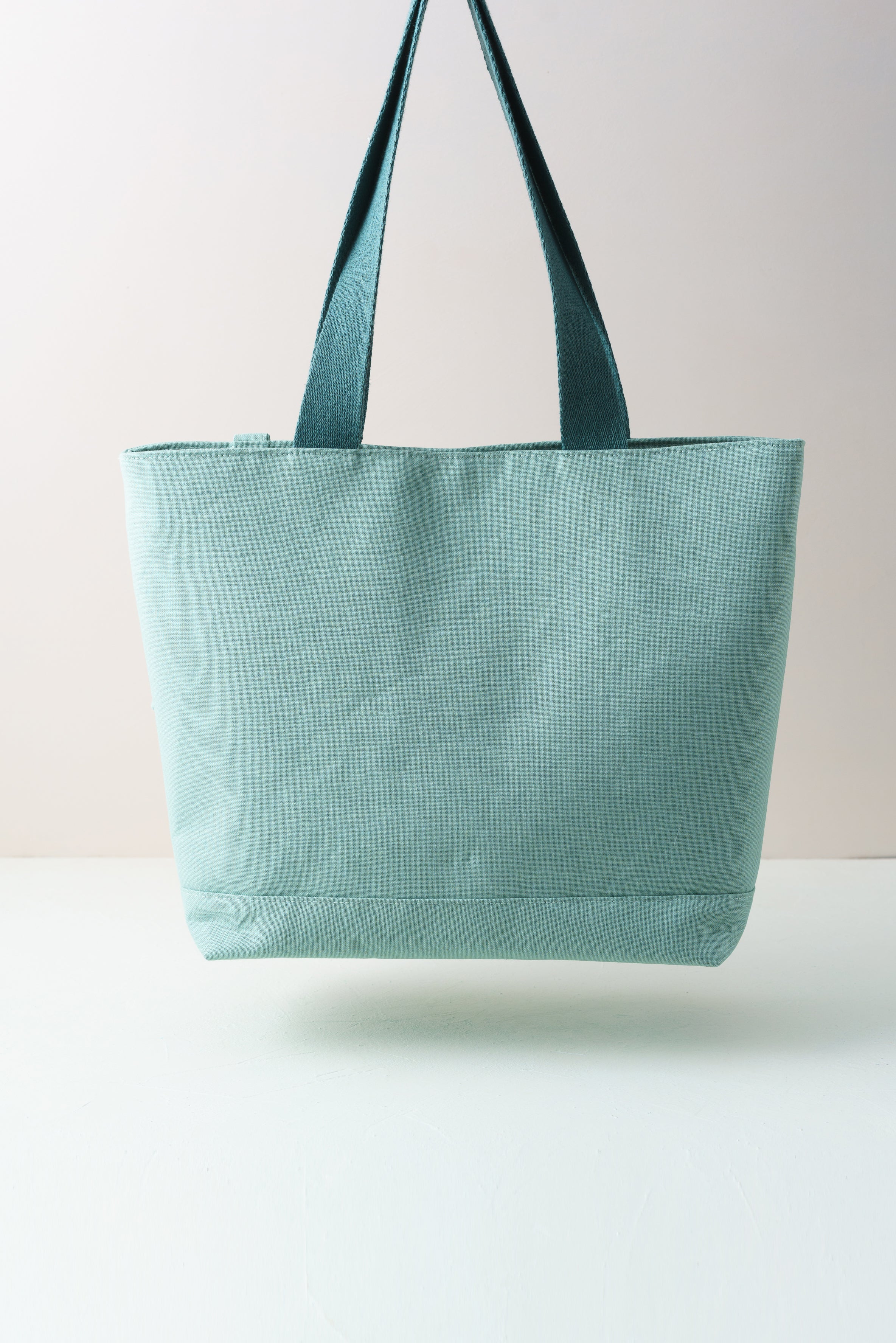 Türkiser Shopper mit Pfingstrosenmuster und Taschenbaumler